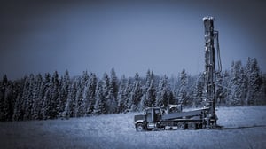 Truck drilling on an open field.