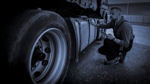 Man inspecting a truck